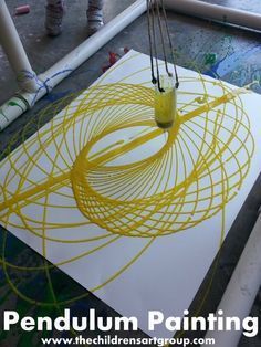 an art project with yellow paint on white paper