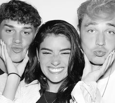 three people posing for a photo with their hands on their faces and one person holding his chin up