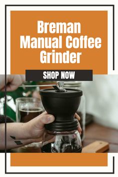 a coffee grinder sitting on top of a table next to a person holding it