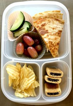 a plastic container filled with food on top of a table