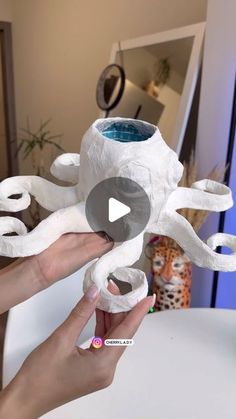 someone is making an octopus sculpture out of toilet paper and glue on the inside of it