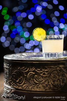 a glass filled with a drink sitting on top of a table