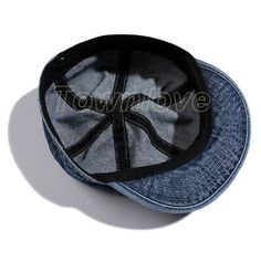 a denim cap with black stitching on the front and side, against a white background