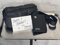 a black bag with a happy holidays note on it and other items sitting next to it