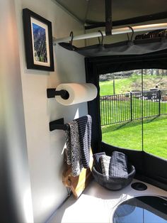 there is a room with a window that looks out onto the grass