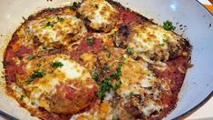 a close up of a plate of food with meat and cheese on the top,