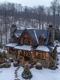 this is an aerial view of a house in the snow with christmas lights on it