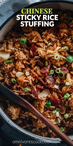 chinese sticky rice stuffing in a skillet with wooden spoon and green onions on the side