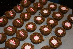 there are many cookies with candy canes on the top one is brown and white