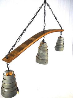 three bells hanging from a long wooden beam