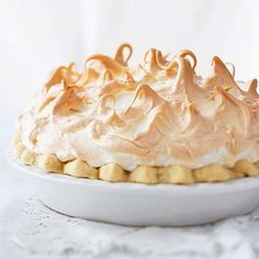 a white plate topped with a cake covered in frosting on top of a table