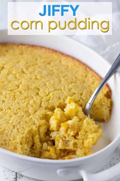 a bowl filled with corn pudding on top of a table