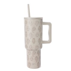 a white cup with a straw sticking out of it's side, on a white background