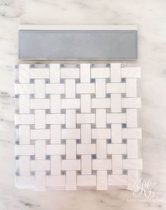 a white and grey tile pattern on a marble counter top