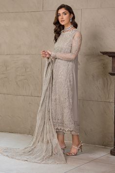 Pakistani Silver Embroidered Long Kameez with Capri Party wear a soothing combination of light beige and skin, Cheryl has been brought to life with heavily patterned florals in same colored threadwork. Blended embroideries on chiffon canvas are sure to fit your festive season wardrobe. Detailed Description: SKU: PB0032 Detailing: Embroidery, Threads, Floral designs Color: Silver Fabric: Chiffon Design: Fully Embroidered dress Event: Festive, Party wear Net Kameez Designs, Net Sleeves, Sister Bridesmaid, Net Shirt, Pakistani Boutique, Desi Wear, Desi Clothes, Chiffon Collection, Embroidered Sleeves