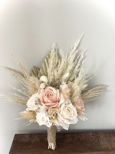 a bouquet of flowers on top of a wooden table