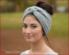 a woman wearing a gray headband and smiling at the camera