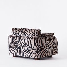 a zebra print couch sitting on top of a white floor