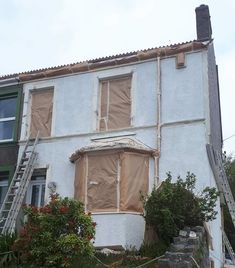 a house that has been boarded up and is being renovated