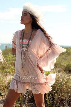 This is a fun & romantic tunic! This super soft boho chic tribal inspired cotton tunic dress / cover-up has embroidery and pom-poms details on the Spring V-neck Beach Dress With Tassels, Spring Beach Cover-up Dress With Tassels, Long Bohemian Dress With Back Tassel Tie-up, V-neck Dress With Back Tassel Tie-up For Summer, Bohemian Tunic Cover-up For Festivals, V-neck Boho Dress With Tassels For Festival, Flowy Hippie Summer Cover-up, Long Hippie Boho Dress For Spring, Summer Boho Dress With V-neck And Tassel Ties