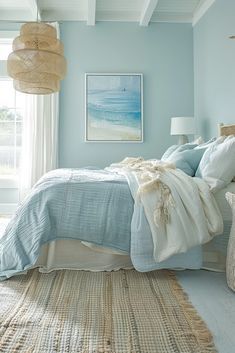 a bedroom with light blue walls and white bedding, along with an area rug on the floor