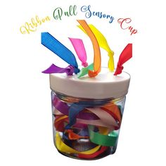 a jar filled with lots of colorful streamers