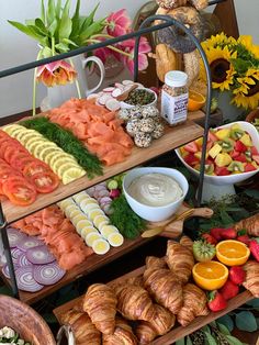 an assortment of food is displayed on a table with flowers and other foodstuffs