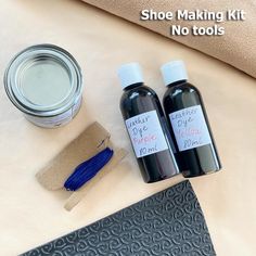 two bottles of shoe polish sitting on top of a table