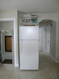 a white refrigerator freezer sitting inside of a kitchen