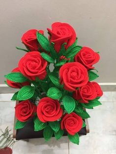 a bouquet of red roses sitting on top of a table