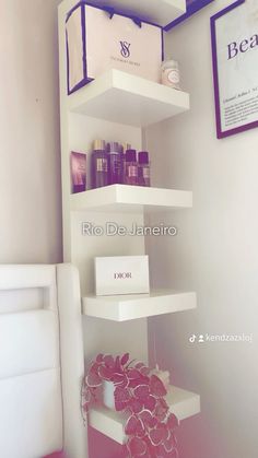 a white shelf filled with cosmetics and other items next to a wall mounted sign that reads rio de janero