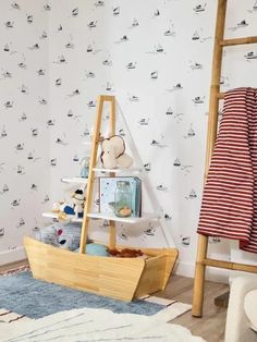 a child's room with a ladder and wallpaper