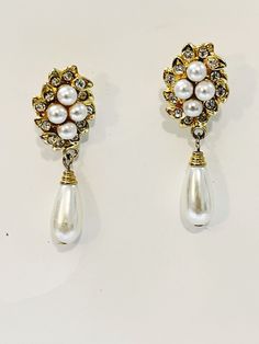 "Vintage Faux Pearl Rhinestone Earrings Drop Dangle Stiletto Earrings Wedding Victorian Pierce Post Gold-tone Earrings Formal Costume Jewelry Super Cute Earrings you can give as a gift to yourself or someone else  Condition: Good Condition  Measurements:    2\" length   2\" drop Check out the earring section of the shop for my vintage jewelry and treasures.  ------------------------------------------------------------ Be sure to check out shop for more retro gifts.  Add to your jewelry collectio Elegant Jeweled Teardrop Dangle Earrings, Formal Jeweled Costume Jewelry Earrings, Wedding Crystal Pearl Drop Earrings, Formal Costume Jewelry Earrings With Jewels, Elegant Gold Teardrop Earrings With Rhinestones, Jeweled Metal Crystal Earrings For Wedding, Formal Jeweled Drop Clip-on Earrings, Formal Jeweled Dangle Bridal Earrings, Elegant Jeweled Metal Clip-on Earrings