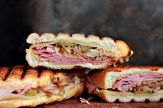 two sandwiches cut in half sitting on top of each other, with meat and cheese