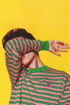 a man with his face covered by a striped shirt