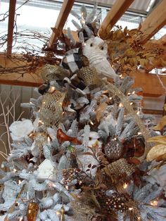 a white christmas tree with silver and gold decorations