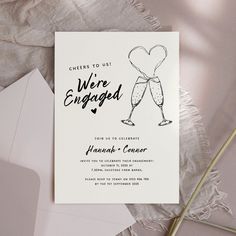 a wedding card with the words cheers to us were engaged and champagne glasses on it