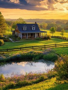 a farm house with a pond in the foreground