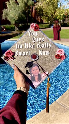 someone holding up a graduation cap that says, you guys i'm like really smart now