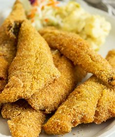 some fried food on a plate with mashed potatoes