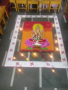 a decorated floor with lights on it and a person sitting in the center surrounded by candles