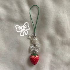 a strawberry with a bow hanging from it's side