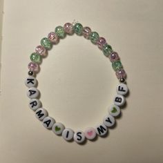 a beaded bracelet with words and hearts on it