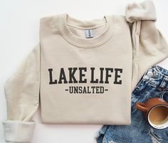 Thank you so much for supporting a small business! Please note that our Christmas deadline is 12/9. Order placed after that may not arrive on time, and we are not responsible for late arrivals due to carrier delays.Get ready to love this lake life sweatshirt!. Is the perfect sweater for family lake vacay! It will make the best gift for  lake house owner  who loves lake camping! Unisex sweatshirt sizing recommendations * Please check size chart before order *For a Slim Fit - Size One Down *For a Lake House Christmas, Lake Shirts For Women, Lake Sayings For Shirts, Lake Tahoe Sweatshirt, Lake Life Sweatshirt, Lake House Gifts, Lake Life Shirt, Lake Camping, Homeowner Gift