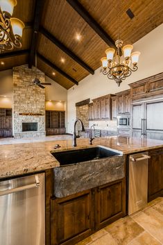 a kitchen with granite counter tops and an island in front of a stove top oven