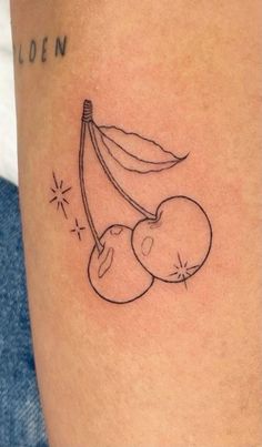 a small tattoo on the leg of a person with a banana and cherries attached to it