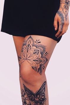 a woman with tattoos on her legs and leggings