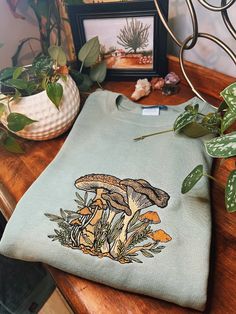 Sage Fungi Foliage Embroidered Crewneck Unisex Embroidered - Etsy Cotton Fall Sweatshirt With Mushroom Print, Cotton Sweatshirt With Mushroom Print For Fall, Winter Cotton Tops With Mushroom Print, Earthcore Aesthetic, Goblincore Cottage, Current Aesthetic, Cottagecore Indie, Teen Outfits, Casual Outfit Inspiration