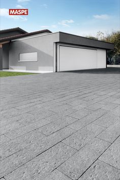 an empty driveway in front of a house