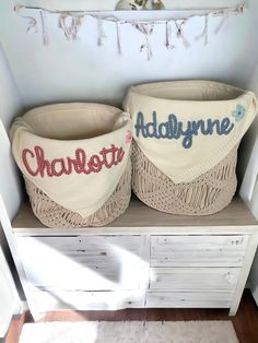 two crocheted baskets sitting on top of a wooden shelf next to a white dresser